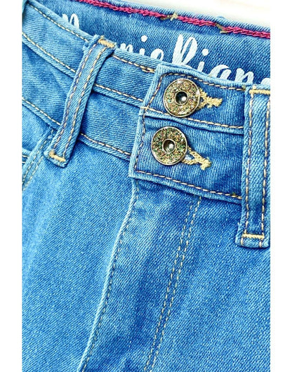 Close-up of blue denim jeans with brand name on pocket