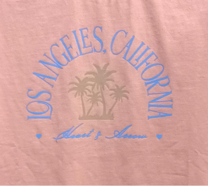 Pink shirt with 'Los Angeles, California' text and palm tree design on a white background
