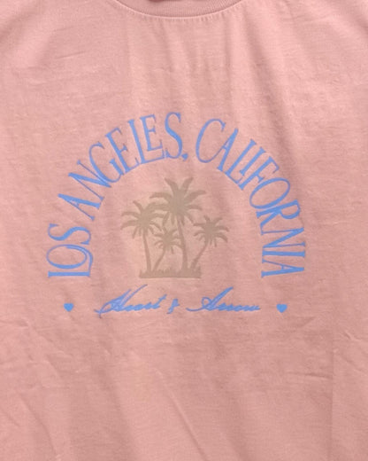 Pink shirt with 'Los Angeles, California' text and palm tree design on a white background