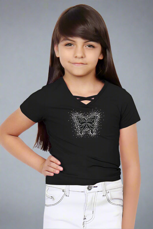 Young girl wearing a black t-shirt with a butterfly design on a white background