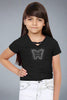Young girl wearing a black t-shirt with a butterfly design on a white background