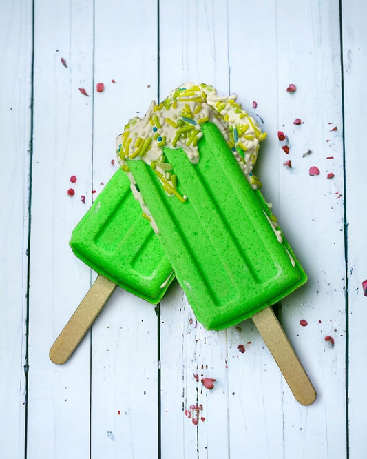 Two popsicle bath bomb - green against a wooden background