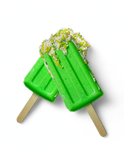 Two popsicle bath bomb - green against a white background