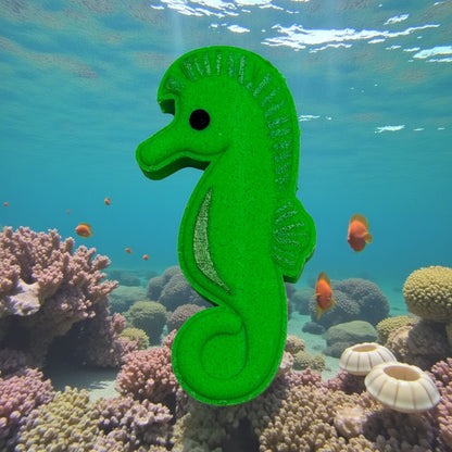 Green seahorse bath bomb in an underwater scene with coral and fish