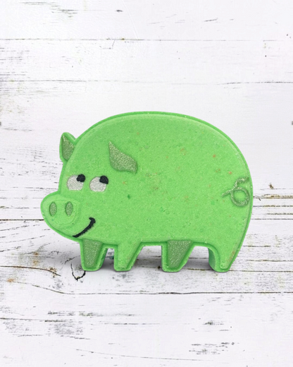 Green pig-shaped object on a white wooden surface