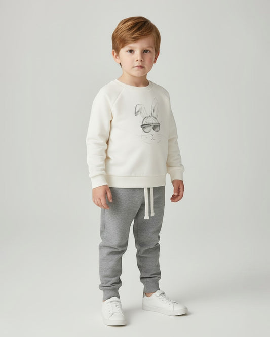 Children's outfit with cream sweatshirt and gray jogger pants on a white background