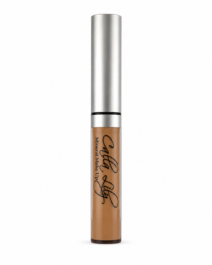 Concealer bottle with silver cap and brown body on a white background