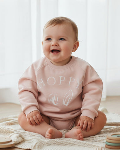 Pink sweatshirt with 'HOPPY' text on a white background