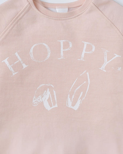 Pink sweatshirt with 'HOPPY' printed in white on a light pink background