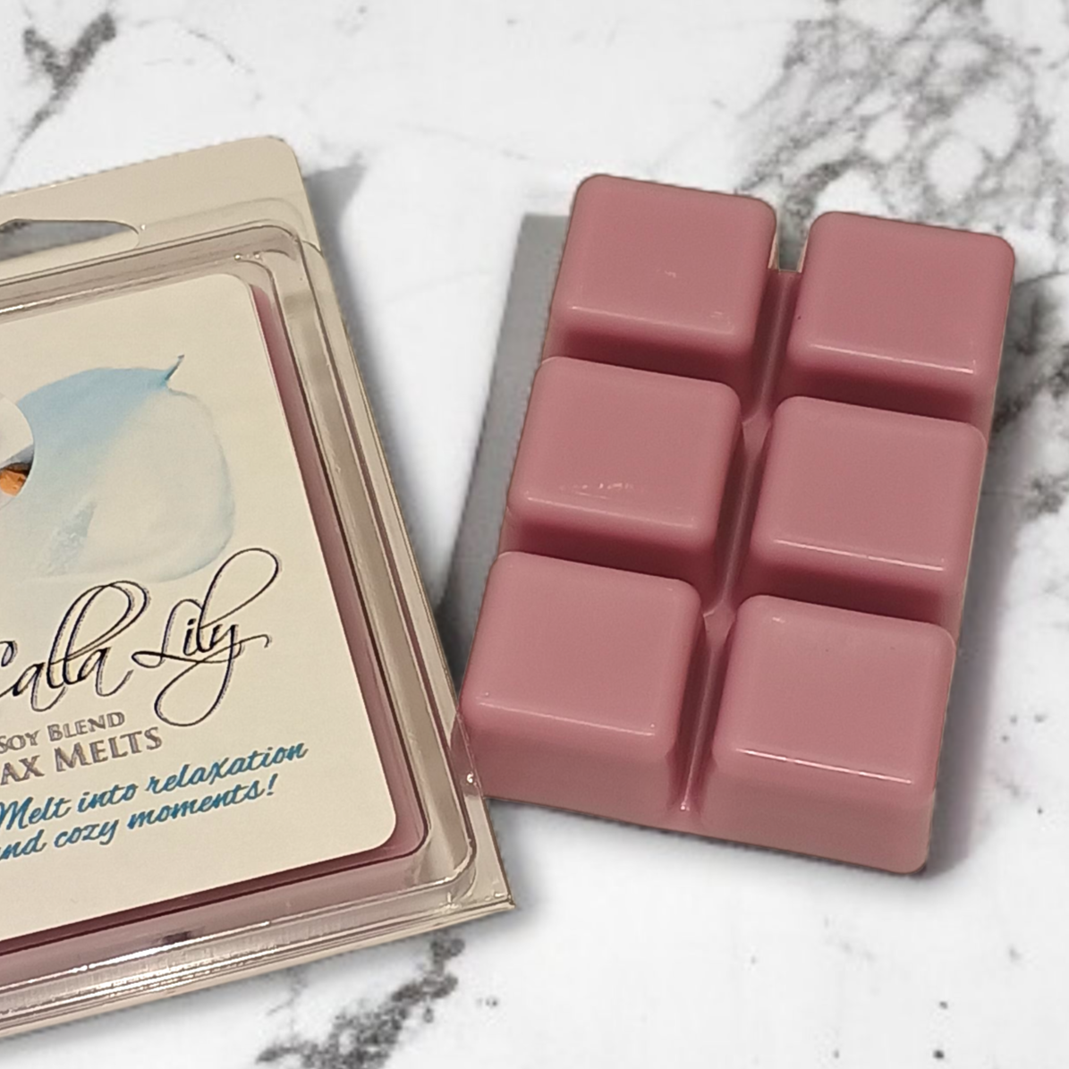 Pink wax melts in a packaging on a marble surface
