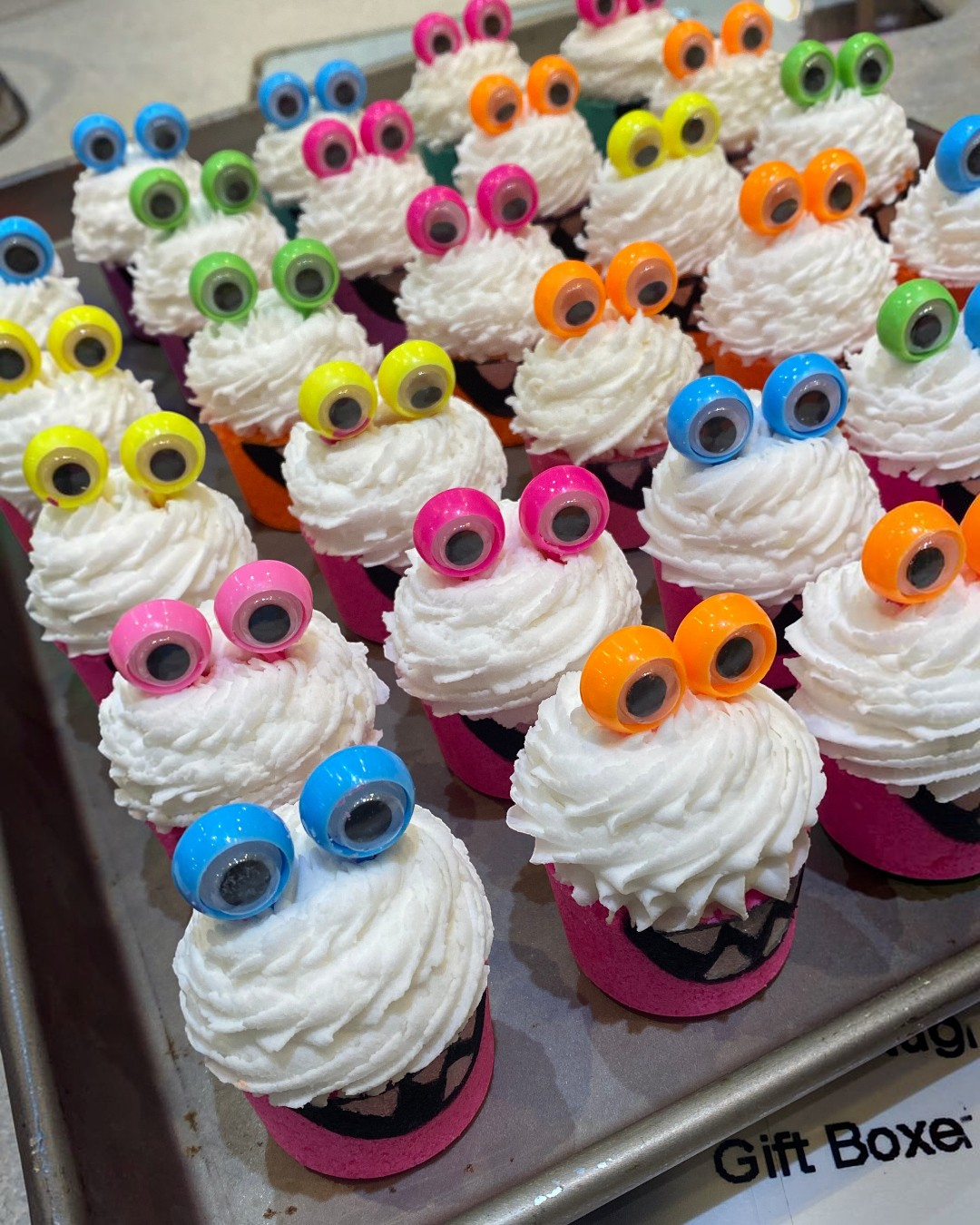 Calla Lily Cosmetics + CL kids monster bath bombs with white bubble icing and googly eyes on a tray