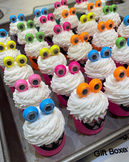 Calla Lily Cosmetics + CL kids monster bath bombs with white bubble icing and googly eyes on a tray