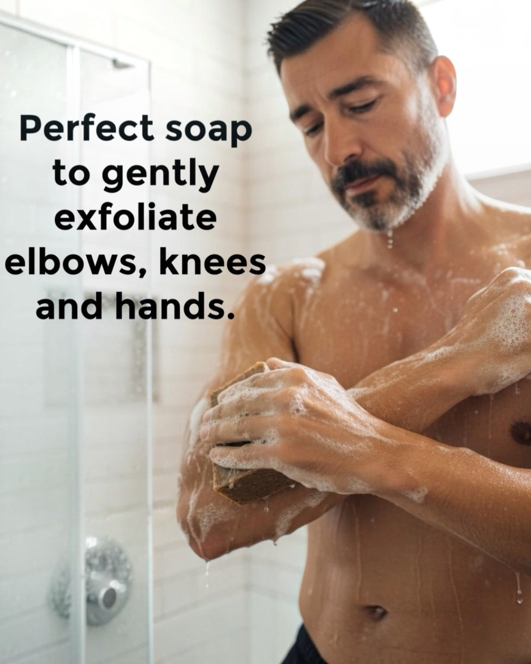Man using Calla Lily Cosmetics + CL kids coffee scrub bar soap to exfoliate his arm in a shower