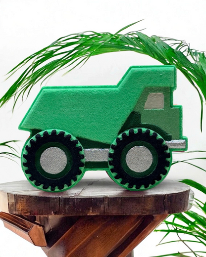 Calla Lily Cosmetics + CL kids green dump truck bath bomb with citrus scent on a wooden stand