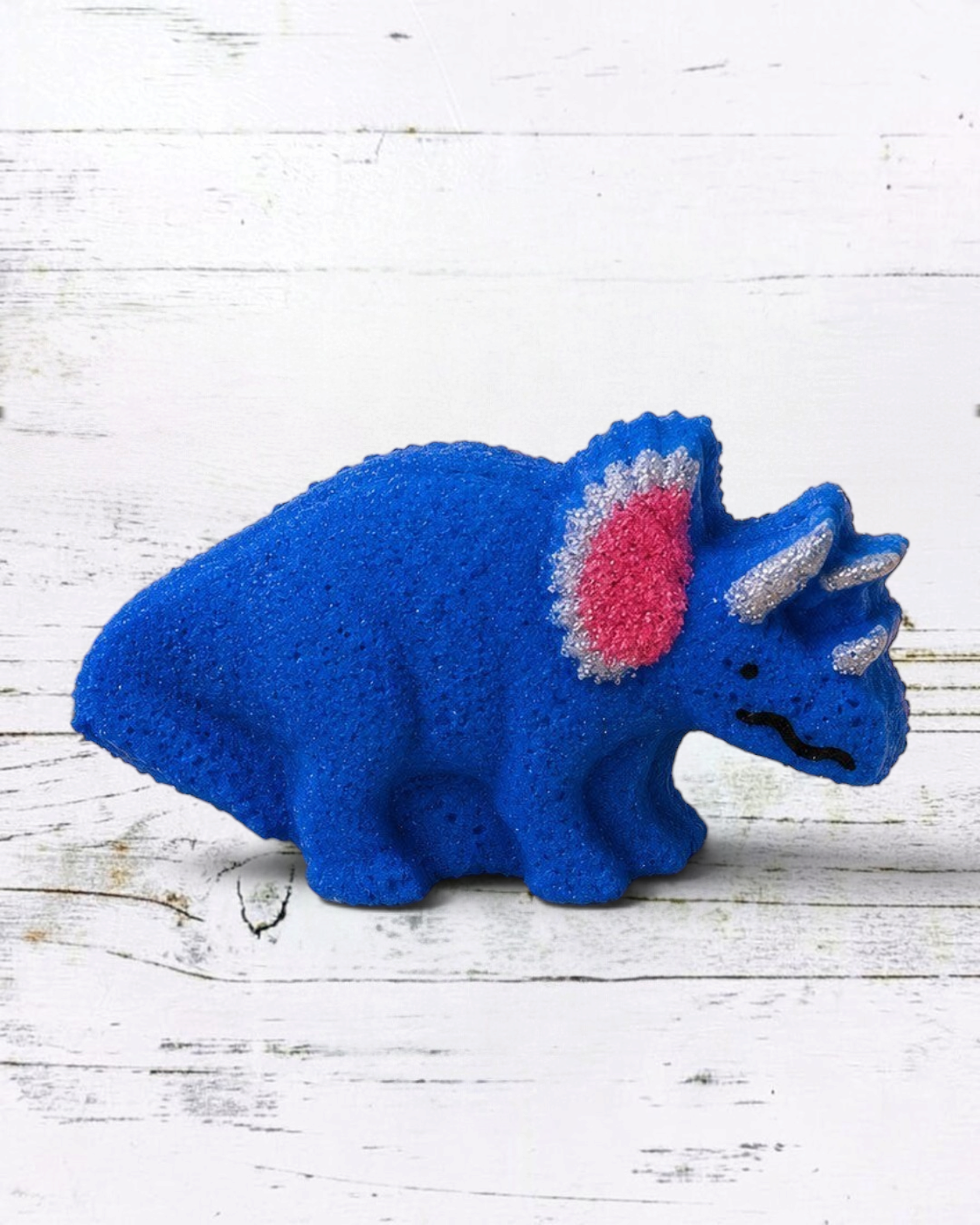 Calla Lily Cosmetics + CL kids blue triceratops dinosaur bath bomb with pink frill and blueberry scent