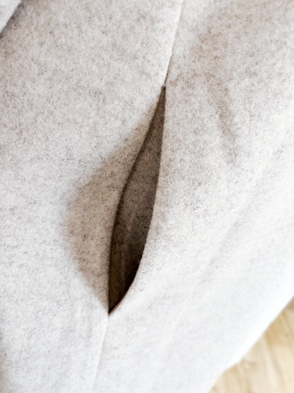 Close-up of a textured fabric with a pocket detail