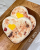 Calla Lily Cosmetics + CL kids heart-shaped goat milk bath bomb with dried rose petals and a yellow center accent