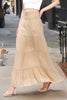 Person wearing a beige tiered skirt on a city street.