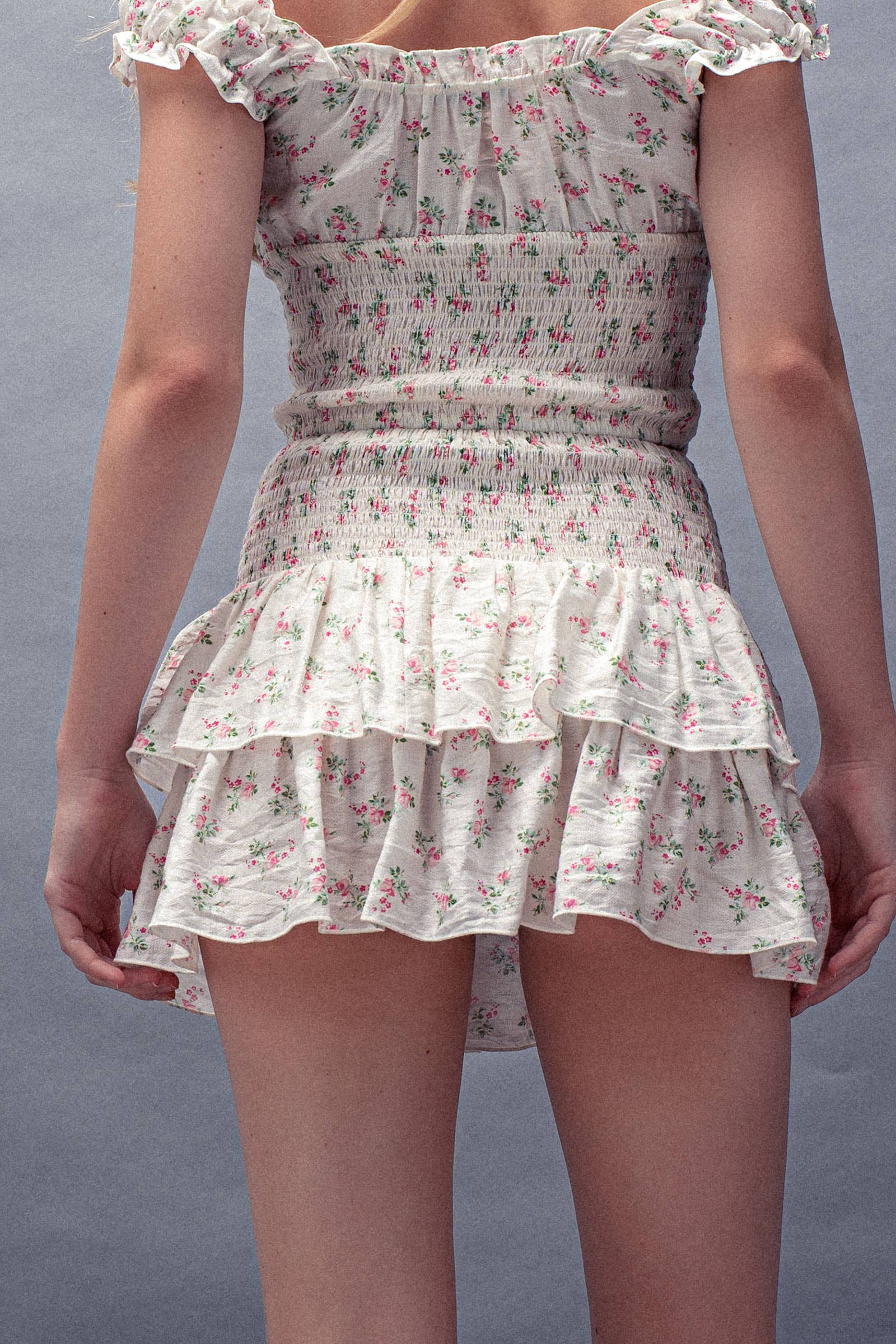 Floral dress with ruffled layers on a plain background