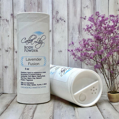 Body powder container labeled 'Lavender Fusion' by Calla Lily Cosmetics on a wooden surface with a wooden wall background.