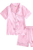 Pink satin pajama set with shirt and shorts on a white background