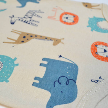 Close-up of fabric with colorful animal patterns on a beige background