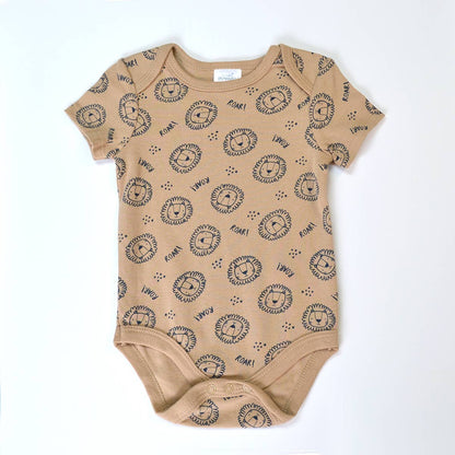 Beige baby onesie with black lion print on a white background