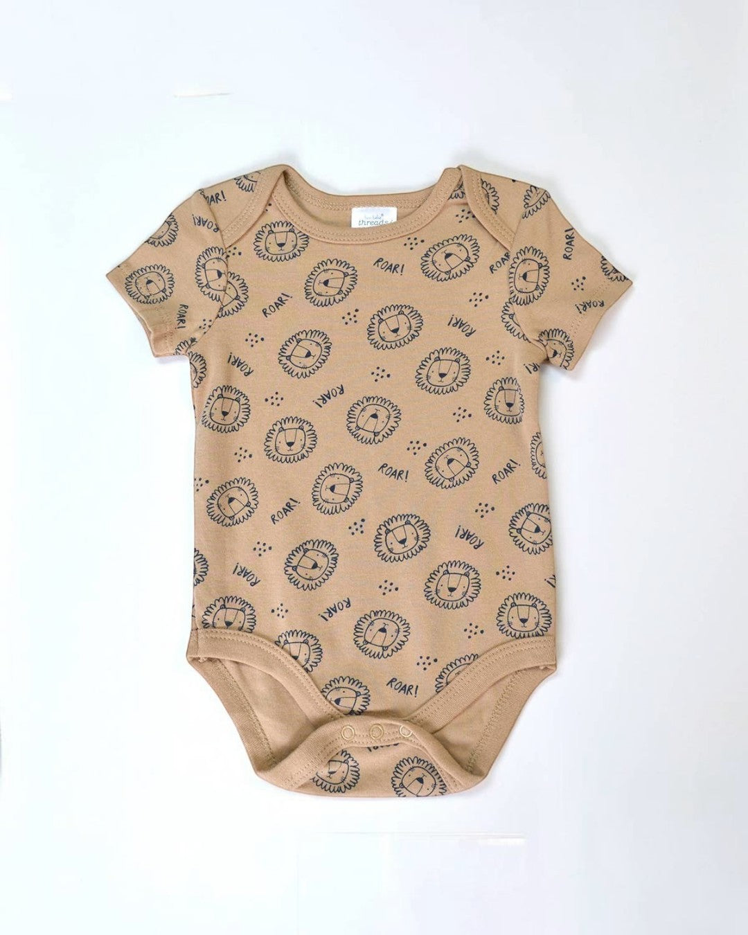 Beige baby onesie with black lion print on a white background