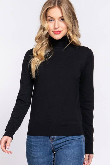 Woman wearing a black turtleneck sweater and blue jeans on a white background