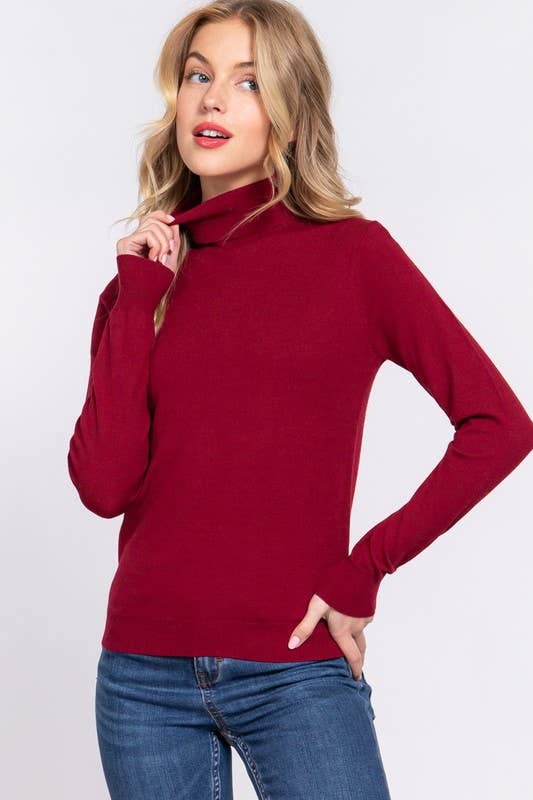 Woman wearing a red sweater and blue jeans on a white background