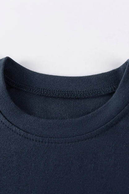 Close-up of a navy blue garment with a white background