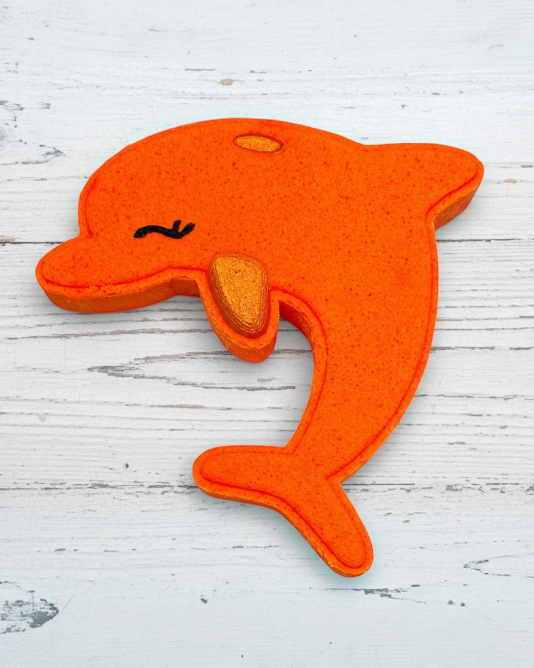 Orange dolphin-shaped object on a white background