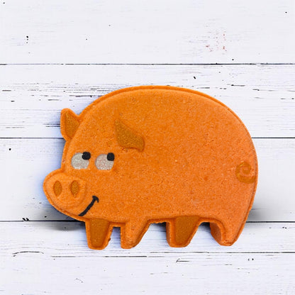 Orange pig-shaped object on a white wooden surface