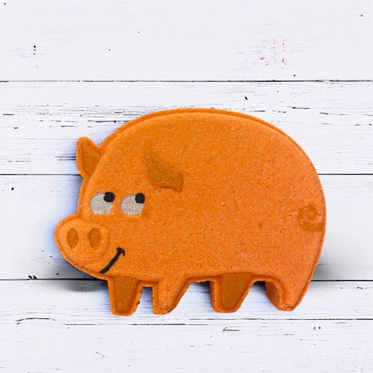 Orange pig-shaped object on a white wooden surface
