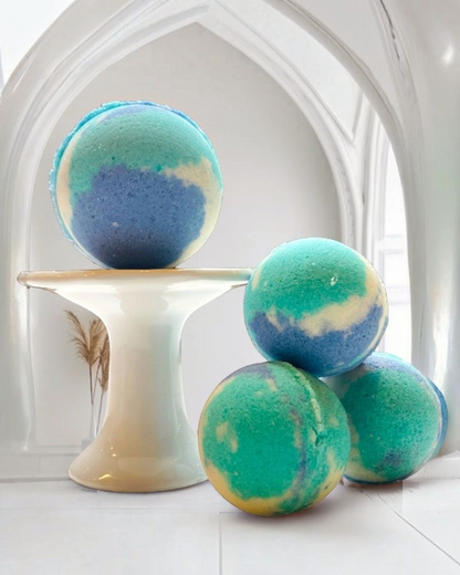 Calla Lily Cosmetics + CL kids Ocean Water bath bombs with blue and green swirls on a white pedestal