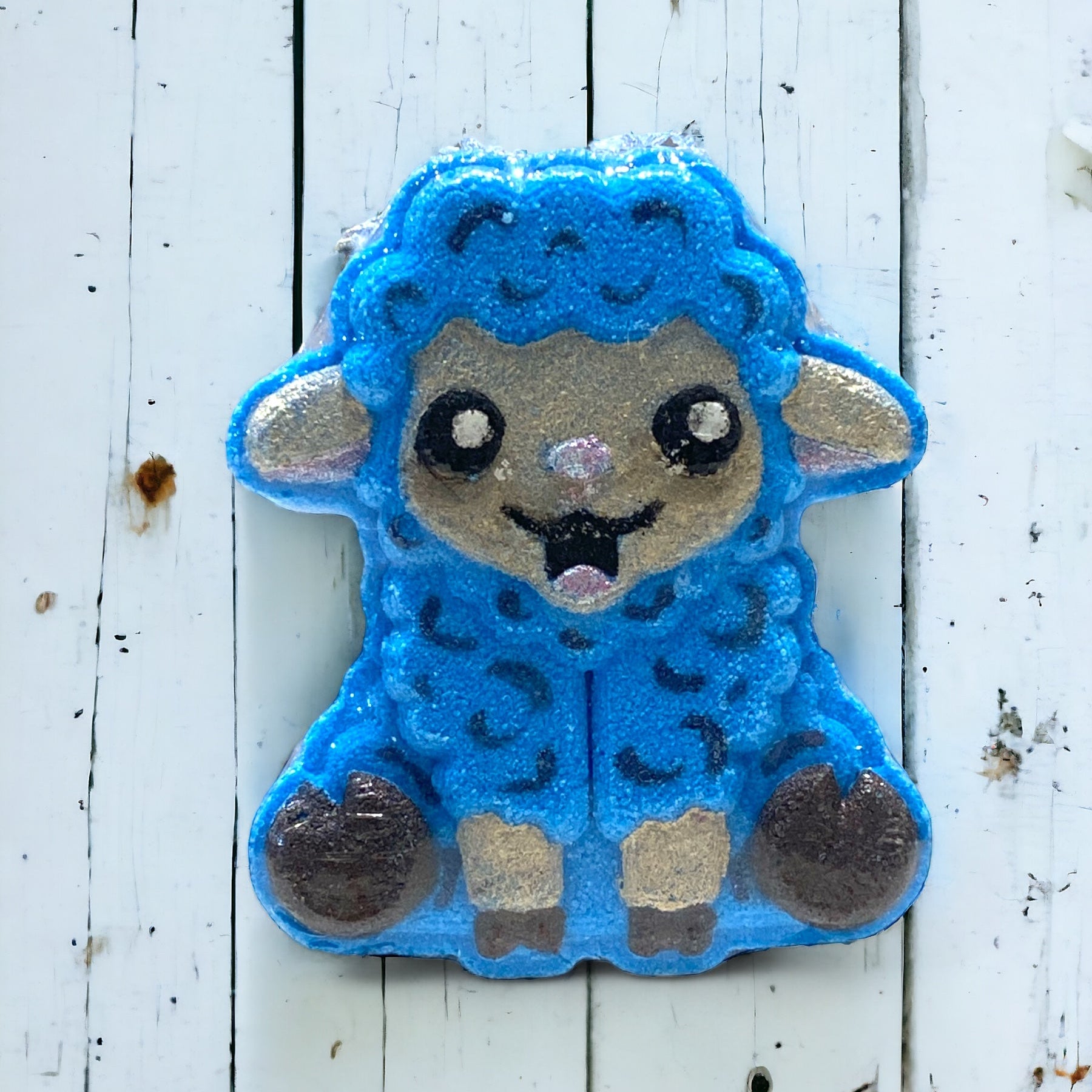 Blue sheep-shaped patch on a white wooden background