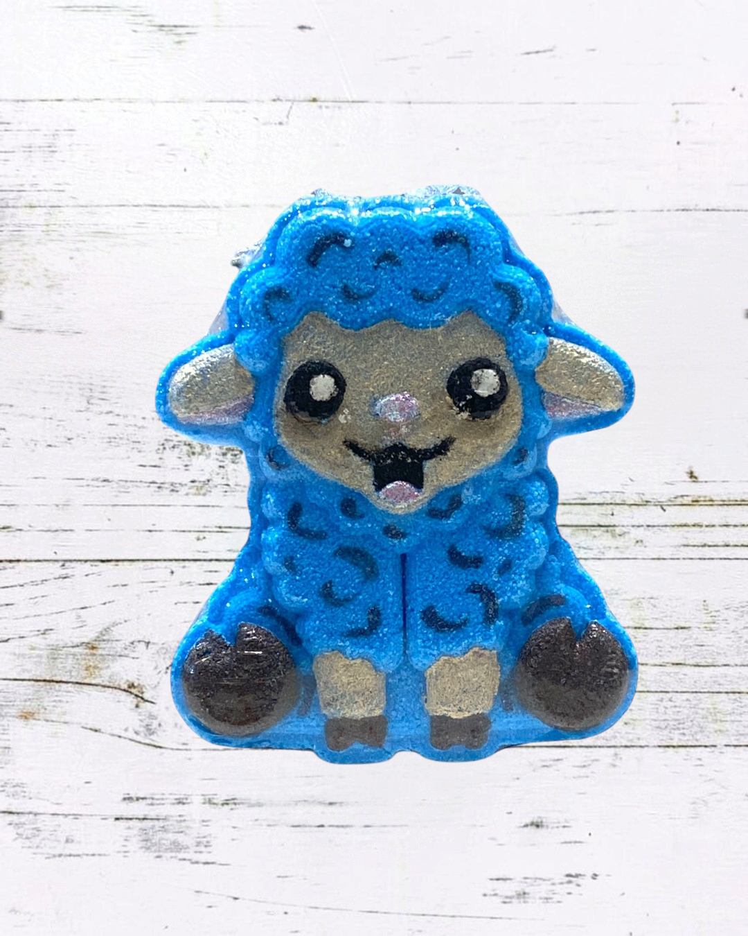Blue sheep-shaped patch on a white wooden background