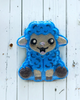Blue sheep-shaped patch on a white wooden background