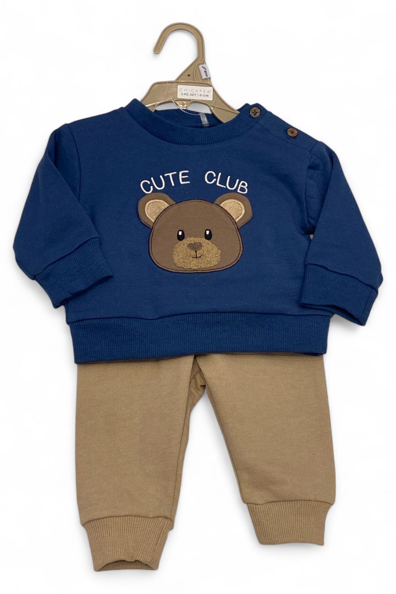 Children's navy blue sweatshirt with bear design and brown pants on a hanger.