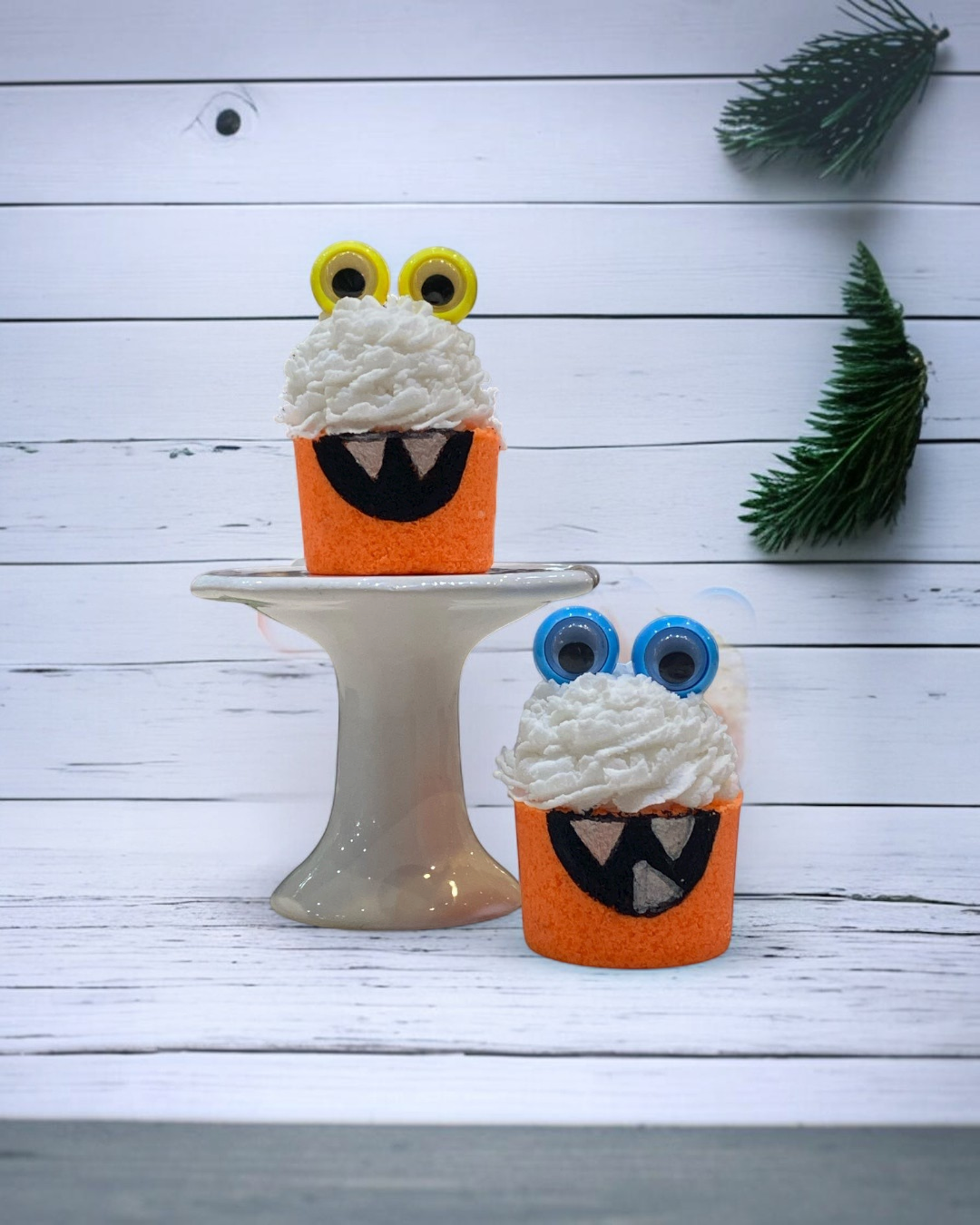 Calla Lily Cosmetics + CL kids orange monster bath bombs shaped like cupcakes with white icing and googly eyes.