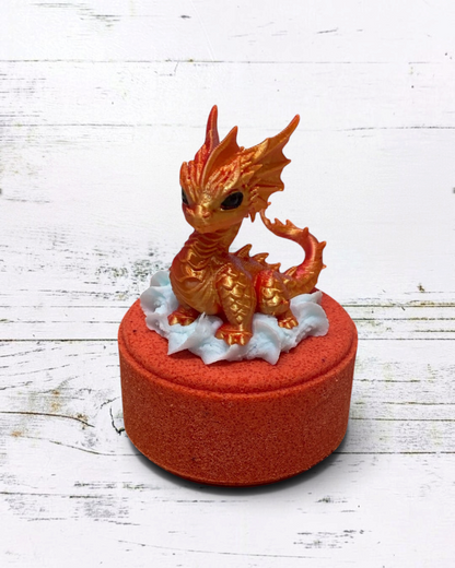 Calla Lily Cosmetics + CL kids Fire Dragon bath bomb with a metallic orange 3D printed dragon toy on a red base