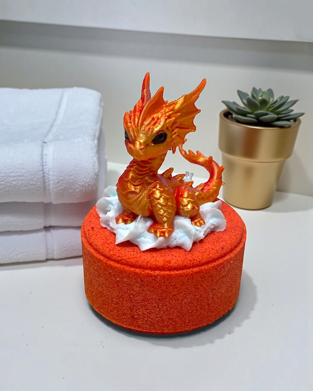 Calla Lily Cosmetics + CL kids Fire Dragon bath bomb with a 3D printed orange dragon toy and blood orange scent