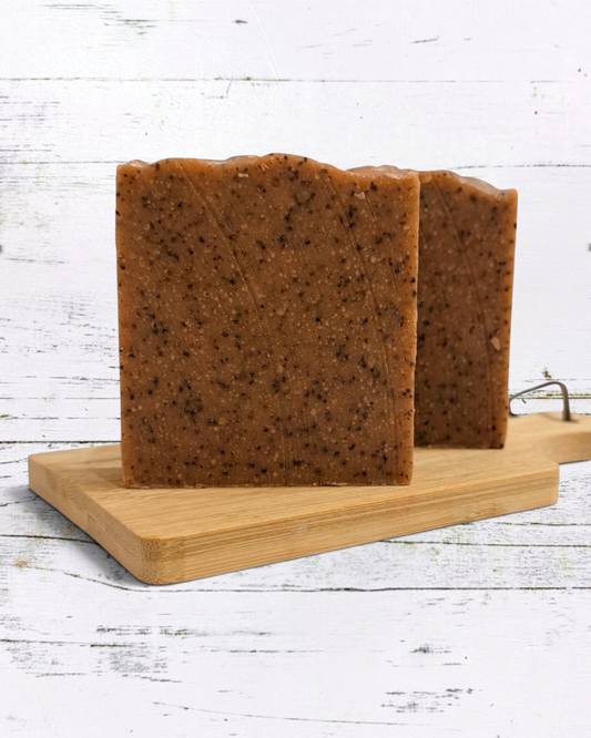 Calla Lily Cosmetics + CL kids exfoliating coffee scrub bar soap with ground coffee on a wooden board