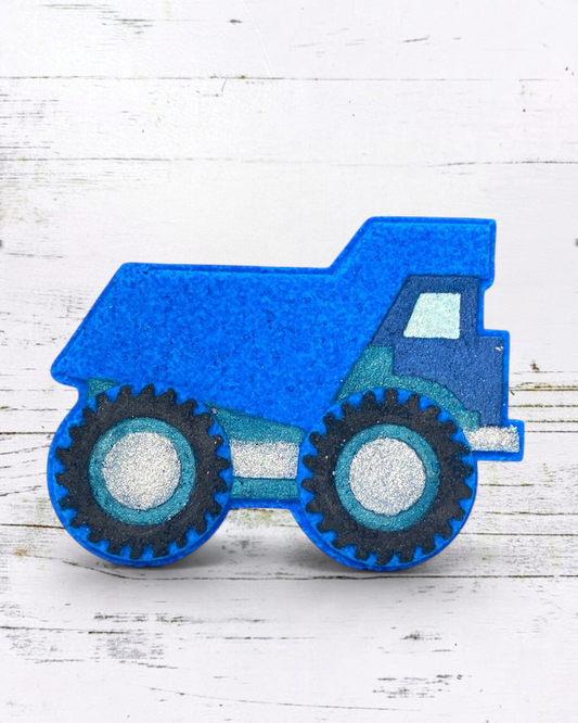 Calla Lily Cosmetics + CL kids blue dump truck shaped bath bomb with blueberry scent and glittery wheel details.