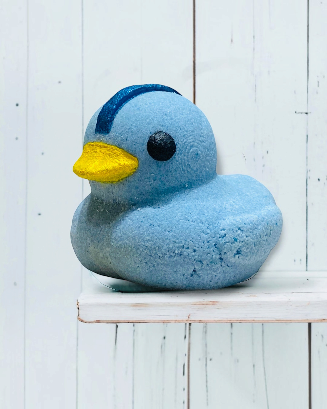 Calla Lily Cosmetics + CL kids blue duck-shaped bath bomb with a yellow beak and blueberry scent for kids