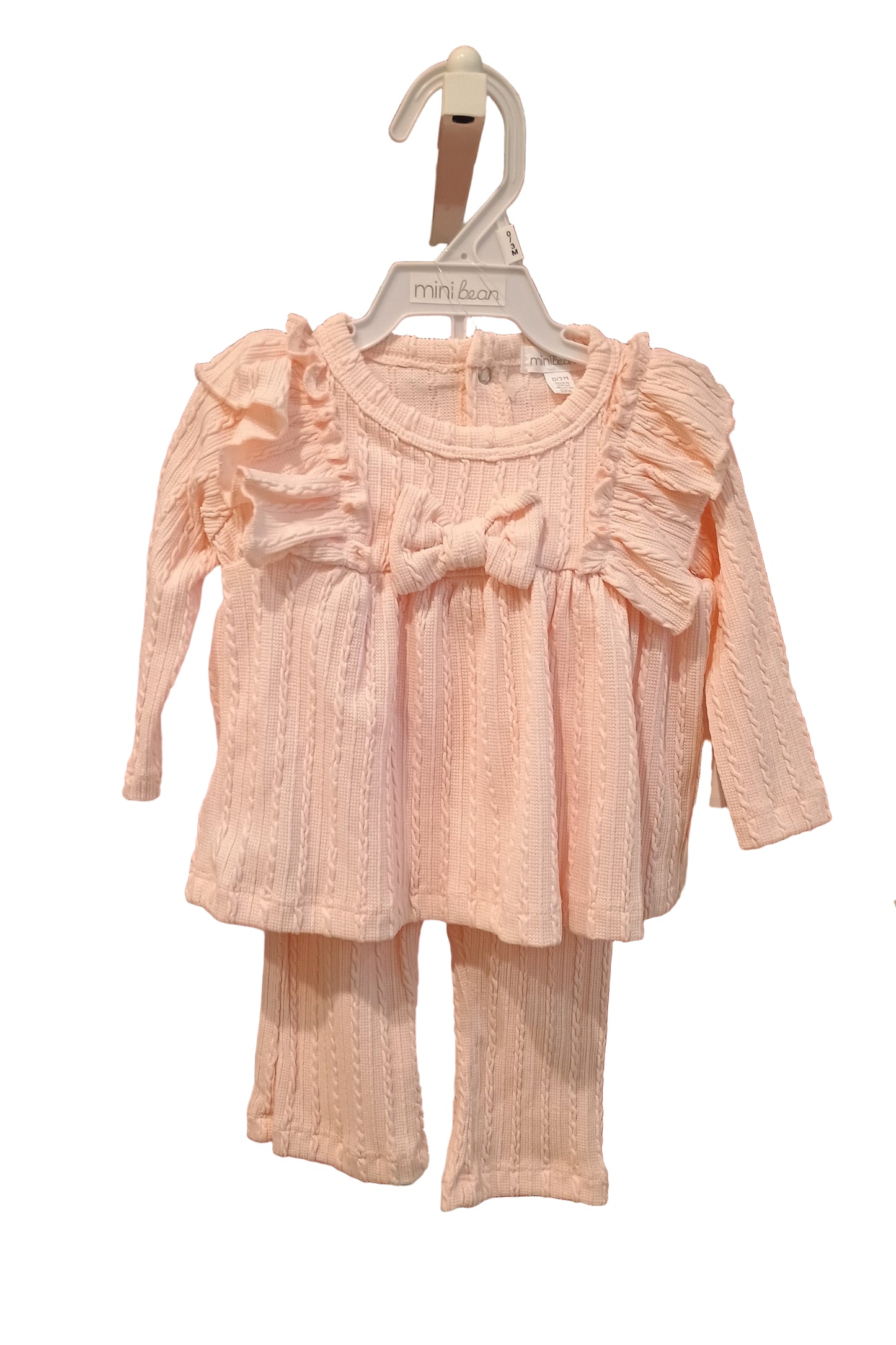 Pink dress on a hanger against a white background