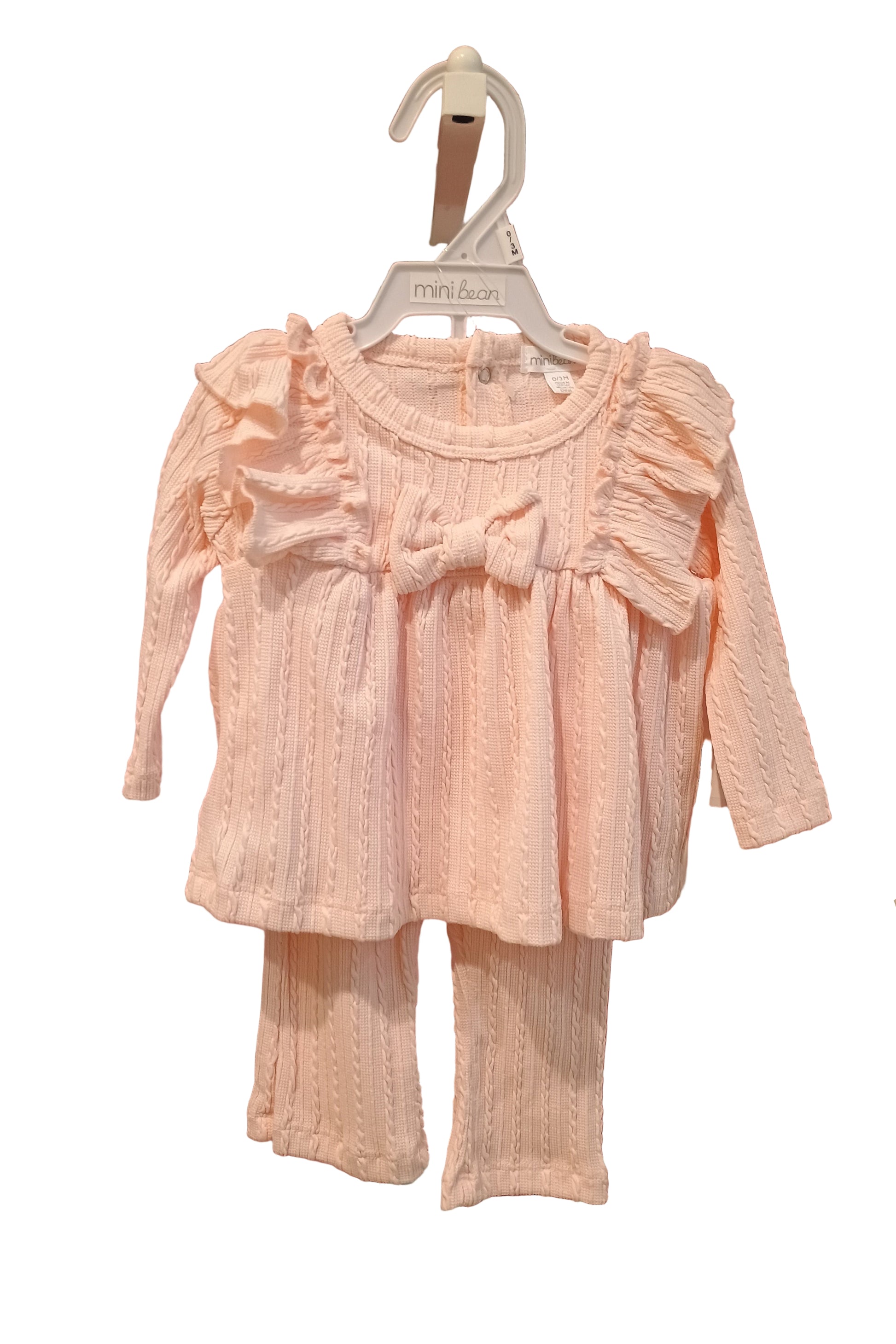 Pink dress on a hanger against a white background