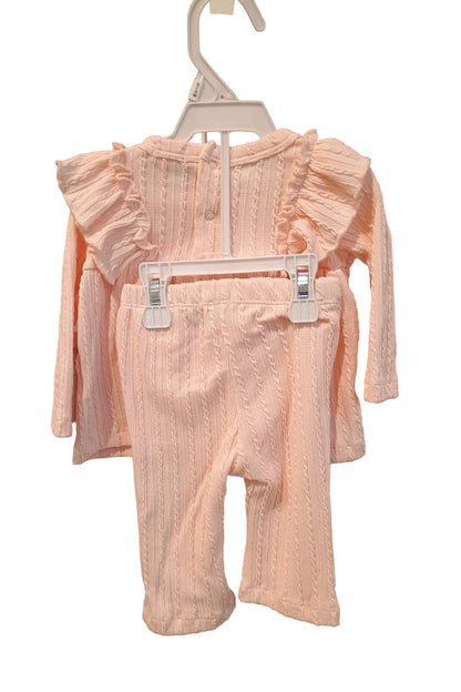 Light pink dress on a hanger against a white background