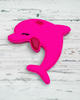Pink dolphin-shaped toy on a white background