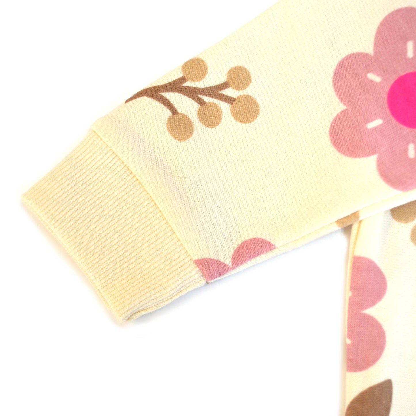 Folded yellow blanket with pink floral patterns on a white background